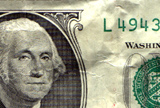 portrait of George Washington from a crumpled dollar bill